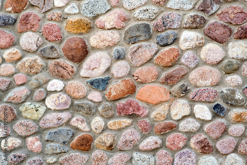 Flat detail view of a wall made from different stones. Abstract stone background.