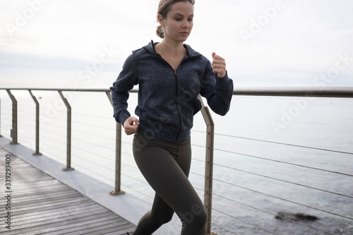 Fototapeta Naklejka Na Ścianę i Meble -  
Female athlete running at seaside 