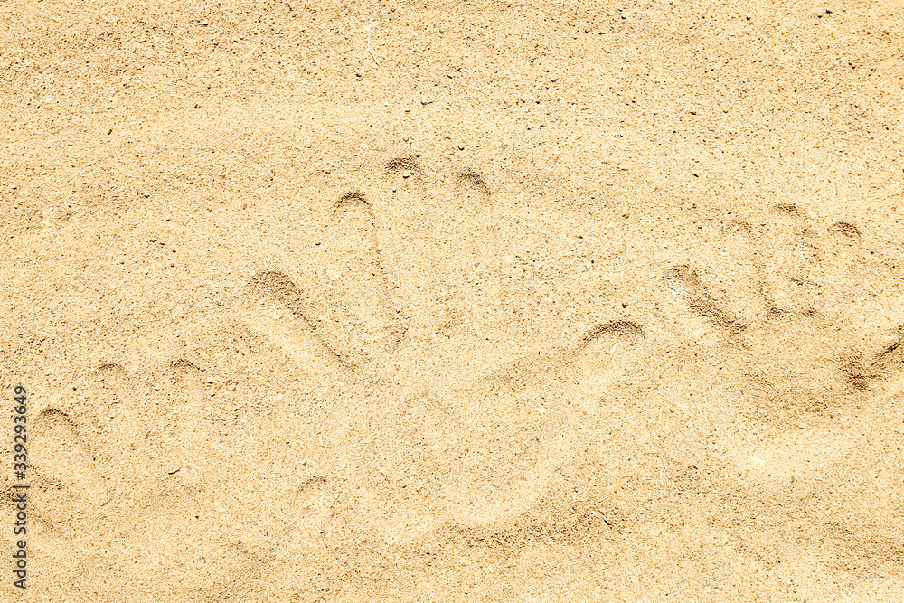 A Drawing in the sand near the sea in nature travel background. Hand drawn on vacation. A Drawing in the sand near the sea in nature travel background. Hand drawn on vacation.