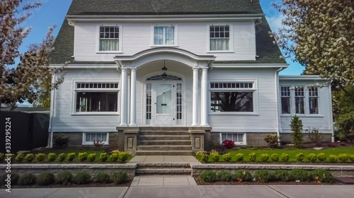 Approaching a white American colonial style house; 4K dolly shot
