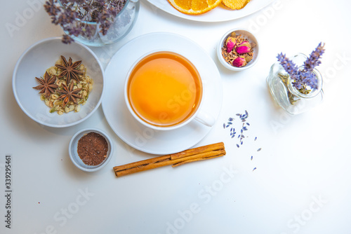still life of medicinal herbs and a mug of herbal tea