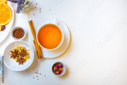 still life of healing herbs and white tea mug on a white background