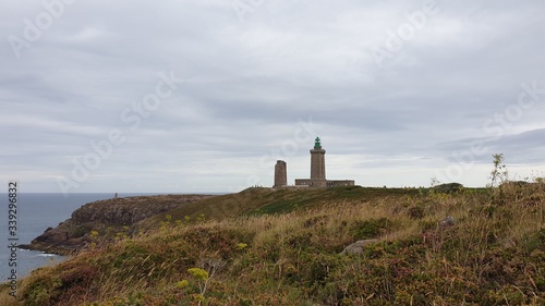 A Coastal Lighthouse In Heathland Near The Sea 