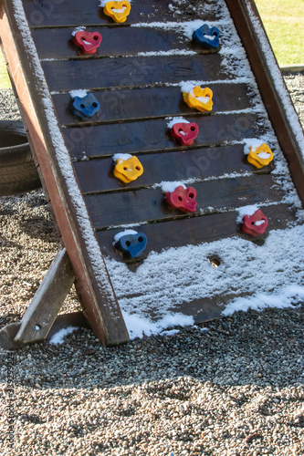 a colorful snowy rock climbing playground wall