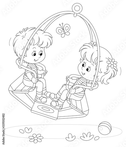 Cheerful small children swinging on a summer playground in a park, black and white outlined vector cartoon illustration for a coloring book page