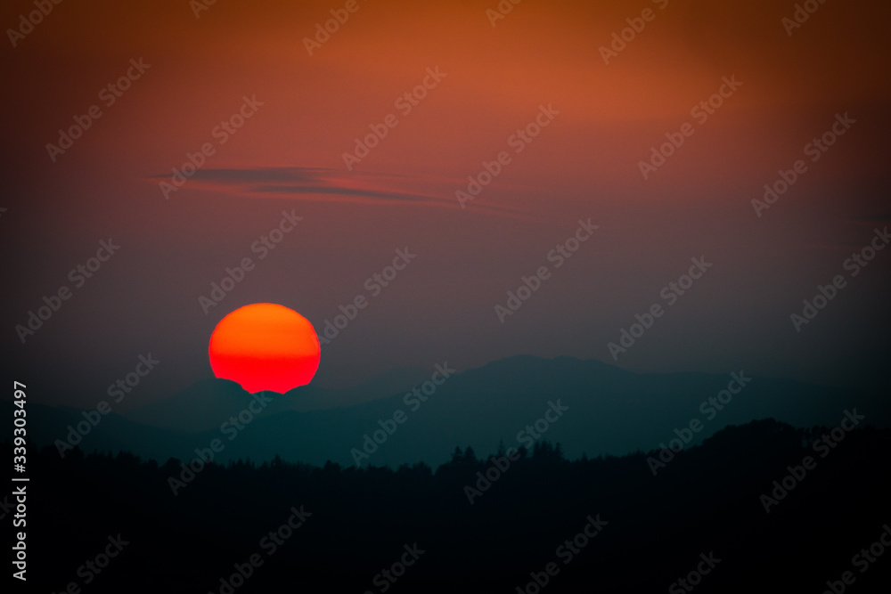 Sunset with disappearing sun over mountains Sunset with disappearing sun over mountains