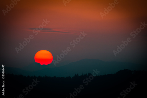 Sunset with disappearing sun over mountains © Charne Hawkes