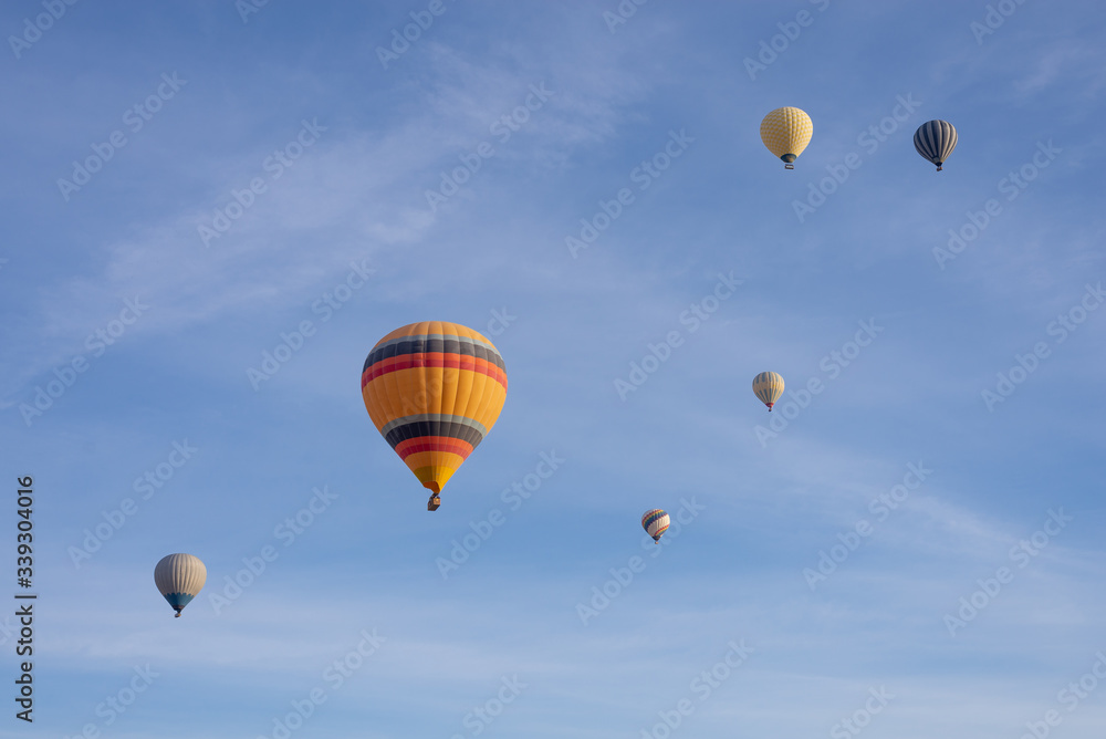 Fototapeta premium Hot air balloons flying in the blue sky in Goreme Cappadocia. Beautifull background texture.