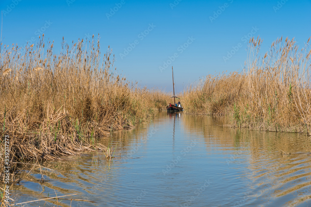 Tourists on a boat in the Albufera nature reserve, El Palmar, Valencia, Comunidad Valenciana, Spain Tourists on a boat in the Albufera nature reserve, El Palmar, Valencia, Comunidad Valenciana, Spain