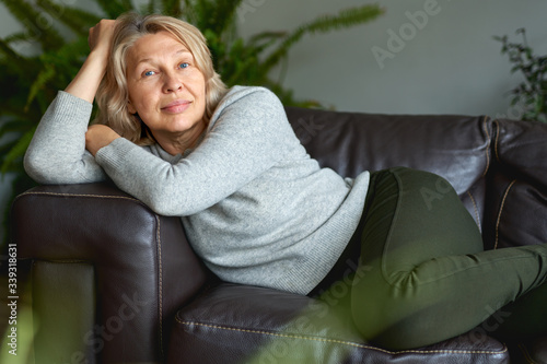 Happy woman is lying on the couch