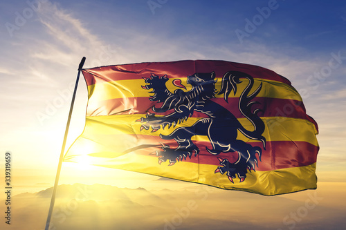 Oudenaarde of Walloon Brabant of Belgium flag waving on the top sunrise mist fog