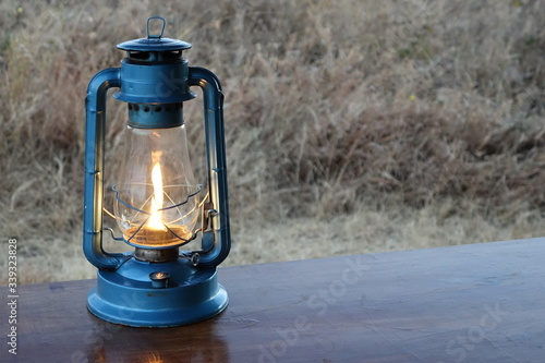 OLD LAMP ON A TABLE WITH SAVANA BACKGROUND - TANZANIA - SERENGETI