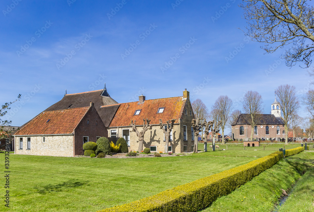 Historic farm and church in small town Sondel, Netherlands
