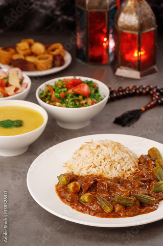 Ramadan. Arabic family dinner. Traditional arabic food. Close-up view. Eid Mubarak. Table with sharing plates food. Ramadan decoration. Lebanese cuisine. Starters, hummus, baklava, dates. Muslim © Maksim Denisenko
