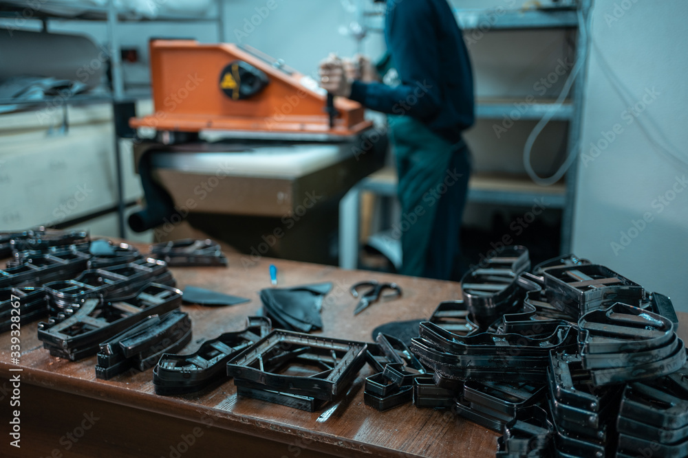 people working with press machinery for cutting shoe leather people working with press machinery for cutting shoe leather