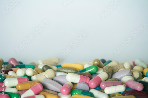 Concept of treatment, options for forms of pharmacological preparations, backdrop of multicolored medicine pills and capsules.