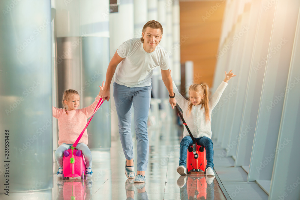 Happy family with two kids in airport have fun waiting for boarding