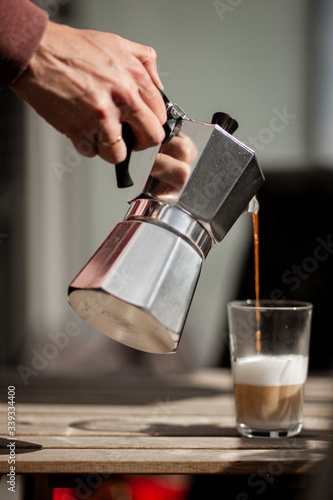 Pouring morning coffee from a Mokka pot