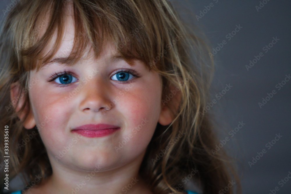 Little girl with blue eyes and rosy cheeks smiling Little girl with blue eyes and rosy cheeks smiling
