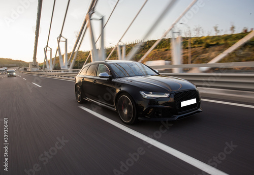 Black sedan car on the design modern bridge