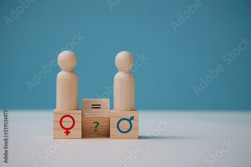 Gender equality. Human rights. Sexual equality. Wooden figures on cubes with feminism and masculism signs, copy space photo
