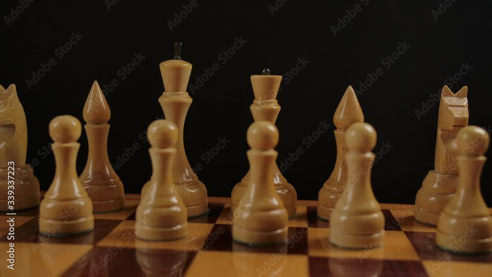 Macro view of white wooden authentic chess on checkerboard. Dolly slider movement close-up. Business strategy in old chess game concept. Macro view of white wooden authentic chess on checkerboard. Dolly slider movement close-up. Business strategy in old chess game concept.