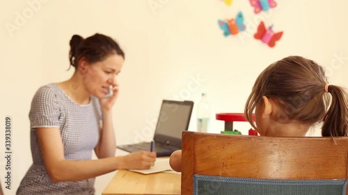  Businesswoman working in homeoffice with her children during Covid-19 shutdown