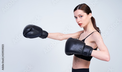 Young athletic caucasian girl in a boxing training. © Svitlana