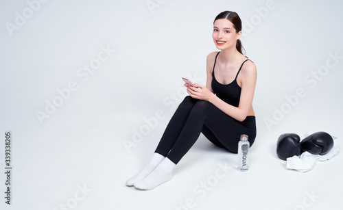 Young woman after boxing workout on a white background.