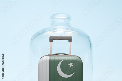 Luggage in isolation under glass cover covid-19 Pakistan tourism abstract.