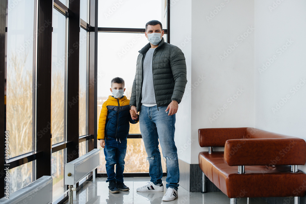 A father with his child stands in a mask during the quarantine. Pandemic, coronavirus A father with his child stands in a mask during the quarantine. Pandemic, coronavirus