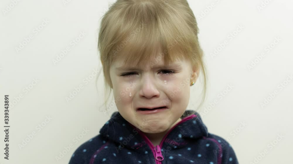 Portrait of little child girl crying with tears down her face. White background Portrait of little child girl crying with tears down her face. White background