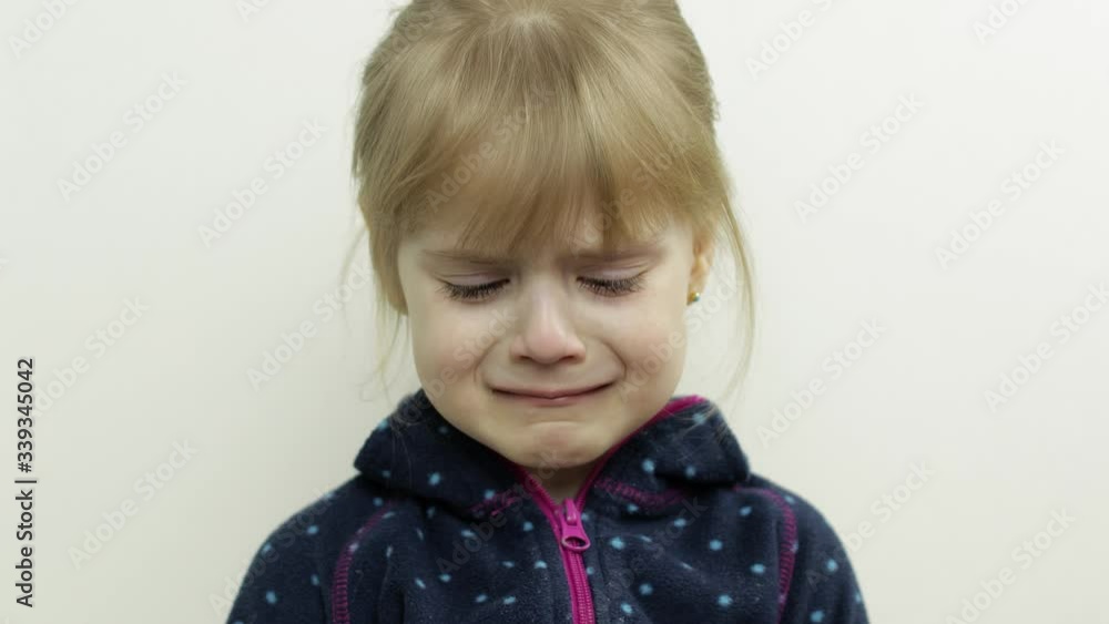 Portrait of little child girl crying with tears down her face. White background Portrait of little child girl crying with tears down her face. White background