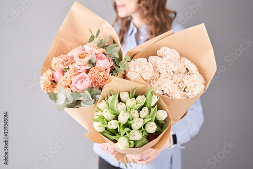Flowers set in womans hands. Fresh cut flowers for decoration home. European floral shop. Beautiful bouquet of mixed flowers . Delivery fresh cut flower.