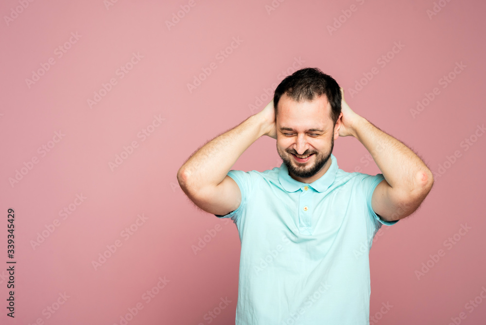 A face of a bearded man on the pink background. A man is glad. A man is happy. Smiling man is pleased. A man with closed-eyes from joy. A man is holding hands behind his head A face of a bearded man on the pink background. A man is glad. A man is happy. Smiling man is pleased. A man with closed-eyes from joy. A man is holding hands behind his head