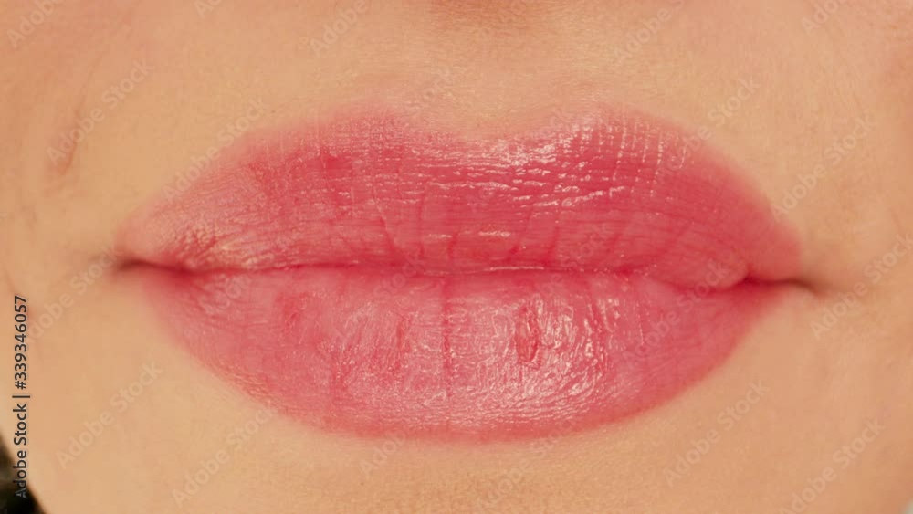 Extreme macro close up of woman lips kissing smiling and licking sexy white teeth shot in 4k Extreme macro close up of woman lips kissing smiling and licking sexy white teeth shot in 4k