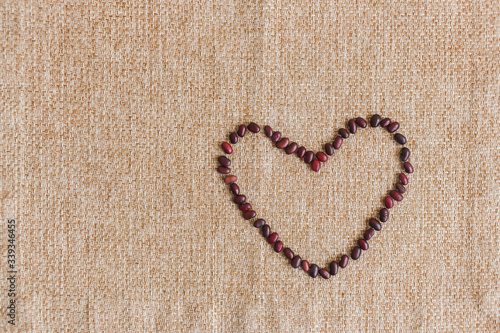 Red bean heart on a burlap table