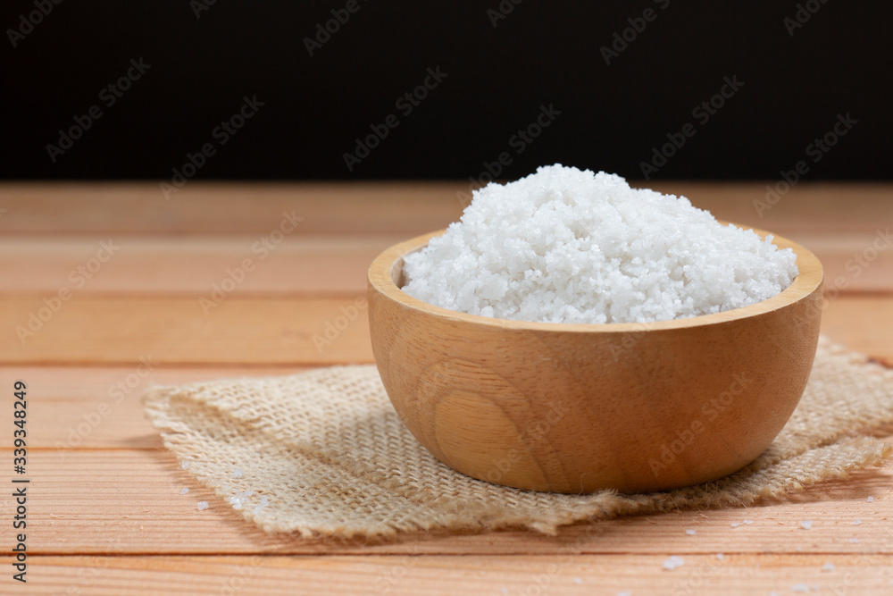 sea salt on wooden plate on wood table. sea salt on wooden plate on wood table.