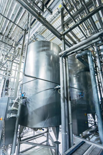 Industrial stainless steel fermentation vats in modern brewery