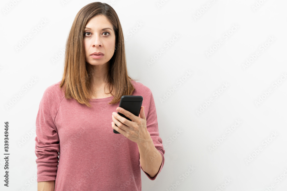 Looking shocked with a smartphone Looking shocked with a smartphone