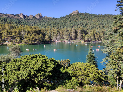 Lake with canoes surrounded by forest in Presa el cedral in Hidalgo Mexico