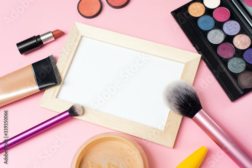 Flat Lay. Decorative cosmetics background. Top view. makeup brushes and cosmetics on a pink background. Mock up for designer and advertising. Place for text