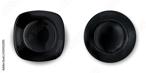 Two empty black plates of different shapes.