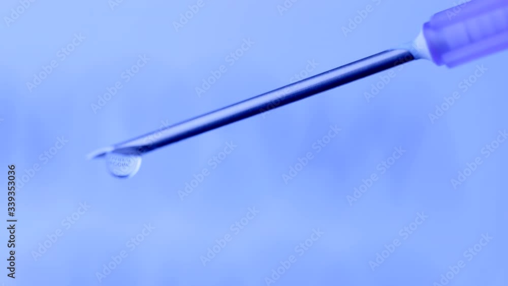 COVID-19 VACCINE DRIPS FROM A SYRINGE. ECU MACRO SHOT IN 4K. NO PEOPLE. COVID-19 VACCINE DRIPS FROM A SYRINGE. ECU MACRO SHOT IN 4K. NO PEOPLE.