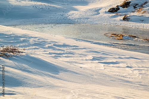 Iced lake in Vivistadir area in Gardabaer at sunrise, Iceland photo