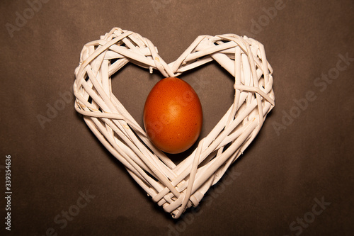 Schilderij op canvas egg in the heart of white wooden branches on a gray background