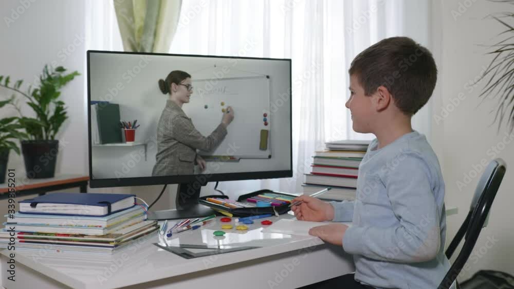 online education, schoolchildren at home teaching does homework using modern technologies for children watching a distance lesson broadcast with his teacher during quarantine in isolation online education, schoolchildren at home teaching does homework using modern technologies for children watching a distance lesson broadcast with his teacher during quarantine in isolation