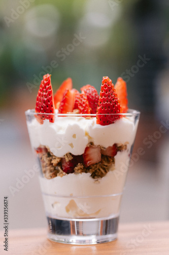 A yogurt parfait with strawberries on top