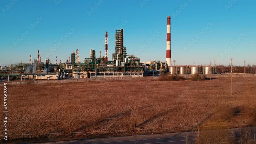 beautiful aerial view large powerful gas and oil refinery industrial complex with pipelines and chimneys near highway road in Russia beautiful aerial view large powerful gas and oil refinery industrial complex with pipelines and chimneys near highway road in Russia