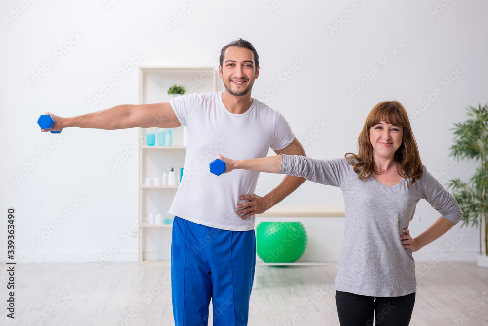 Young woman doing sport exercises with personal coach Young woman doing sport exercises with personal coach